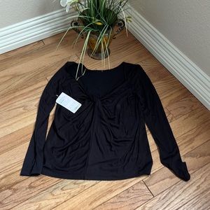 Athleta long sleeve top with knot tie in low cut back.